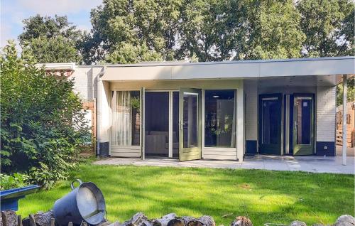 a house with green doors and a yard at Gorgeous Home In Sint-Oedenrode in Sint-Oedenrode
