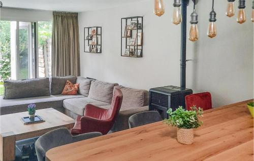 a living room with a couch and a table at Gorgeous Home In Sint-Oedenrode in Sint-Oedenrode
