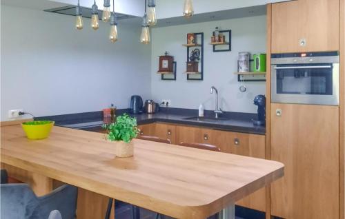 a kitchen with a wooden table in a room at Gorgeous Home In Sint-Oedenrode in Sint-Oedenrode