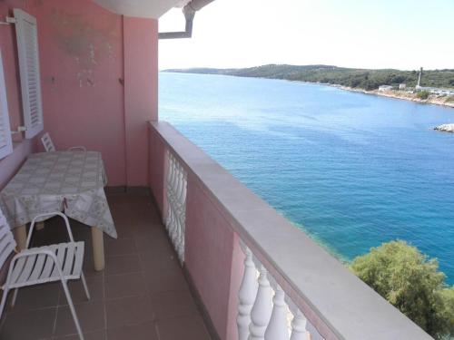 a balcony with a table and a view of the water at Apartment Svetka in Sali