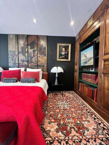 a bedroom with a red bed and a red rug at Villa Pauline in Avignon