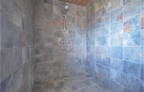 a bathroom with a shower with blue tiles at Stunning Home In Knebel With Sauna in Knebel