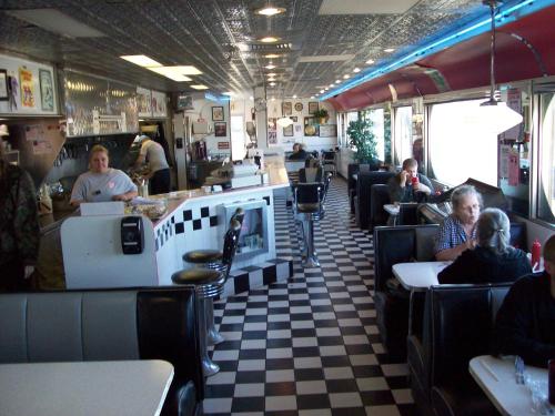 a restaurant with a checkered floor and people eating at Travelodge by Wyndham Dexter in Dexter