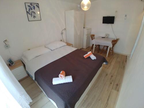 a bedroom with a large bed and a table at Apartment Svetka in Sali