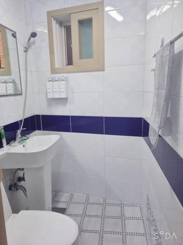 a white bathroom with a sink and a toilet at #A6 Open sale - 5mins to Hongdae Station in Seoul