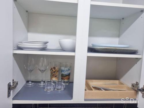 a cabinet with wine glasses and plates on it at #A6 Open sale - 5mins to Hongdae Station in Seoul