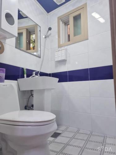 a bathroom with a toilet and a sink and a mirror at #A6 Open sale - 5mins to Hongdae Station in Seoul