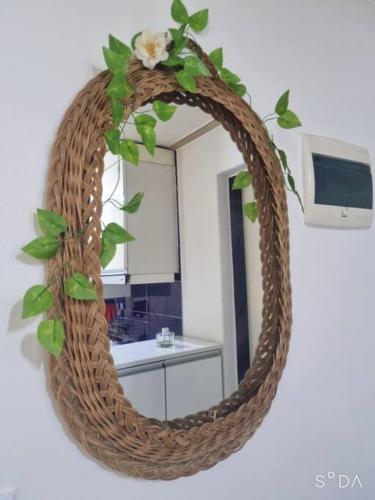 a wicker mirror with a wreath on a wall at #A6 Open sale - 5mins to Hongdae Station in Seoul