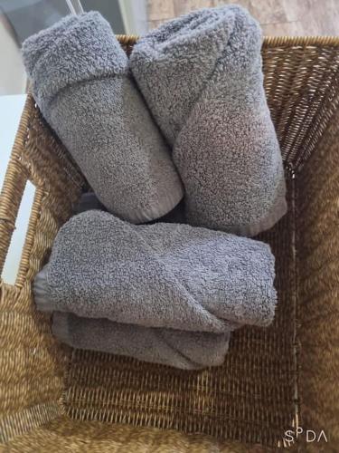 a pile of towels sitting on a wicker basket at #A6 Open sale - 5mins to Hongdae Station in Seoul