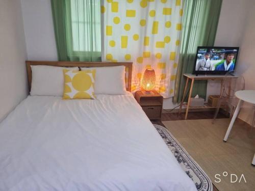 a bedroom with a bed with a television in it at #A6 Open sale - 5mins to Hongdae Station in Seoul