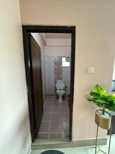 a doorway to a bathroom with a toilet in a room at Jagannath Residency And Prasadam in Kolkata