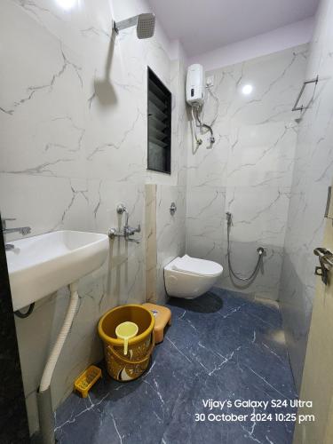 a bathroom with a sink and a toilet at SAGAR Executive LODGE in Akalkot