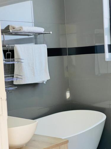 a bathroom with a white toilet and a sink at Purple Steps Guest House in Kimberley