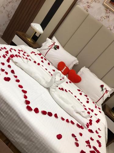 a bed with red hearts on the sheets at سما الرفاع 3 in Al Kharj