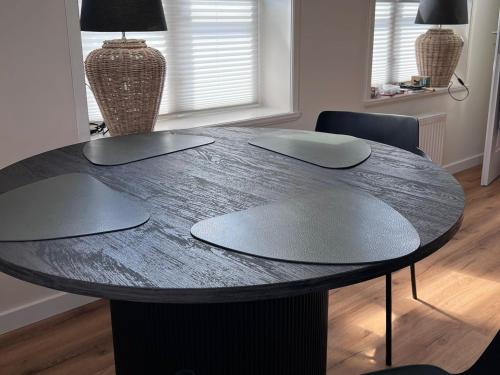 a black table with two chairs and a black table at GUNDT Amrum in Nebel