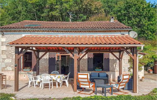 a gazebo with chairs and tables and a table and chairs at 4 Bedroom Lovely Home In Douzillac in Douzillac