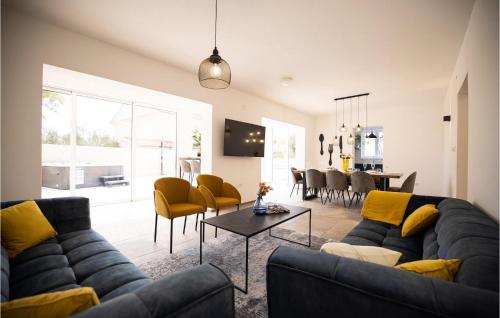 a living room with a couch and a dining room at Villa One Oak in Zadar