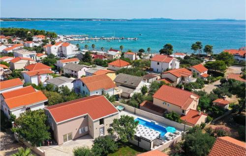an aerial view of a town with houses and the ocean at Villa One Oak in Zadar