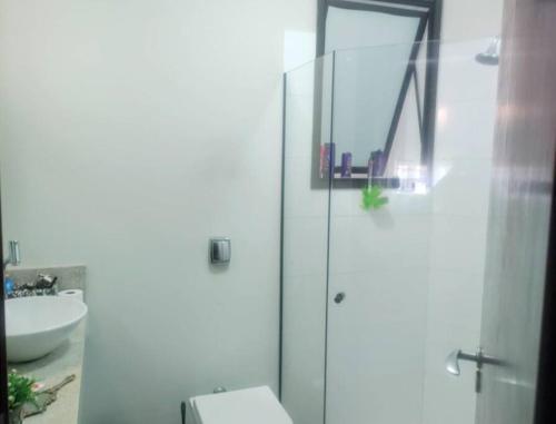 a bathroom with a shower and a toilet and a sink at Refúgio Campodoro in Florianópolis