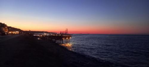 a boat sitting on the water at sunset at Regina in Ortona