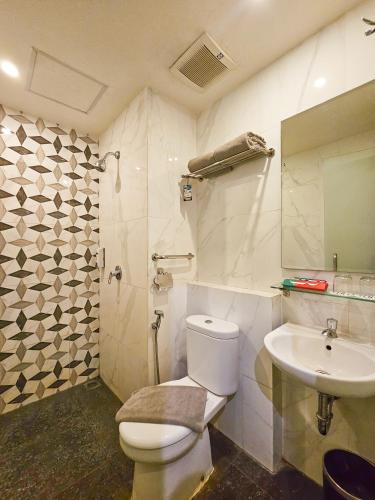 a bathroom with a toilet and a sink at Hotel 88 Kedungsari - Kedungdoro By WH in Surabaya
