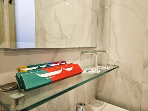 a shelf in a bathroom with a bag on it at Hotel 88 Kedungsari - Kedungdoro By WH in Surabaya