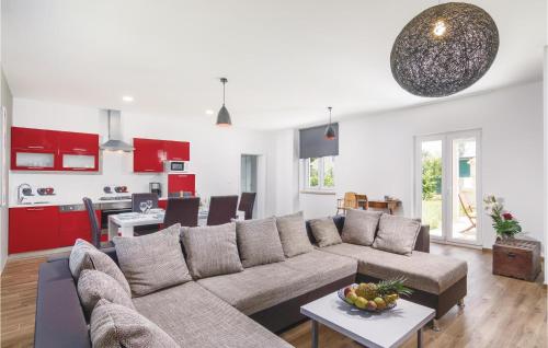 a living room with a couch and a kitchen at Stunning Home In Bale in Bale