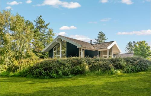 a house with a green yard in front of it at Holiday Home Sivsangervej Ebeltoft Iii in Øksenmølle
