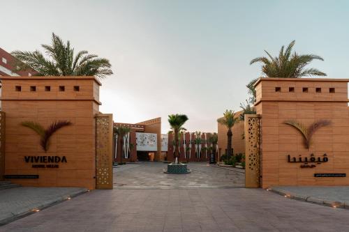 a compound entrance to a resort with palm trees at Vivienda Hotel and Villas, Diplomatic Quarter in Riyadh