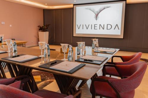 a conference room with a long table and chairs at Vivienda Hotel and Villas, Diplomatic Quarter in Riyadh