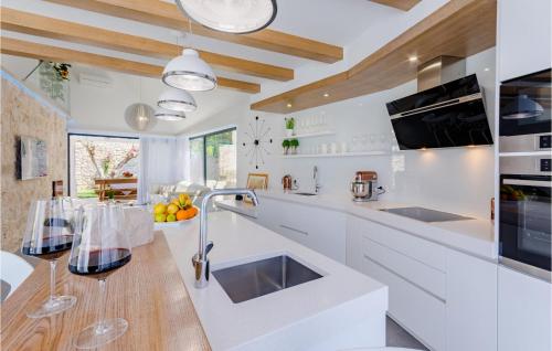 a kitchen with white counters and a wooden counter top at Beautiful Home In Sutivan With Wifi in Sutivan
