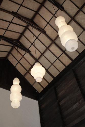 a group of lights hanging from a ceiling at Little Ripper Boutique Lofts in Tanah Lot