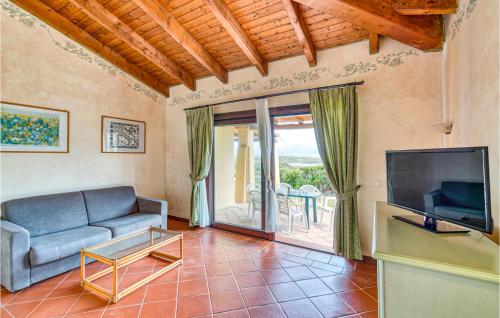 a living room with a couch and a tv at Villa 4 in Stintino