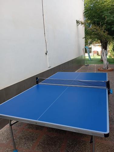 a blue ping pong table in front of a building at Villa Turística Miguel in Pulianas