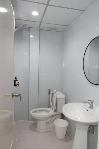 a bathroom with a toilet and a sink and a mirror at Elite Hotel Nana Sukhumvit 3 in Bangkok