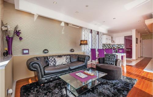 a living room with a leather couch and a table at Cozy Home In Crikvenica With Wifi in Crikvenica