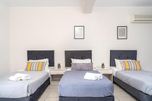 Postel nebo postele na pokoji v ubytování Blue Palm Hotel