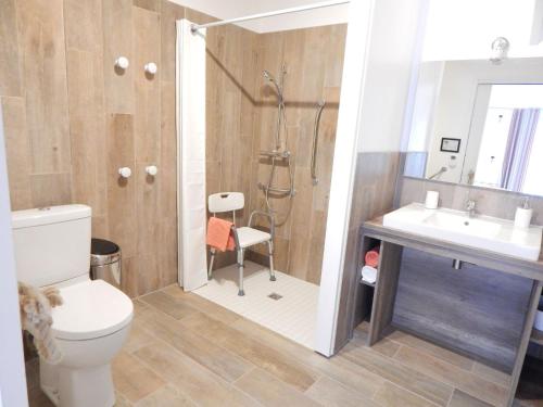 a bathroom with a shower and a toilet and a sink at Balade Océane in Loctudy