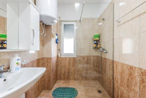 a bathroom with a sink and a shower at The Beachfront Bliss by PS in Golem