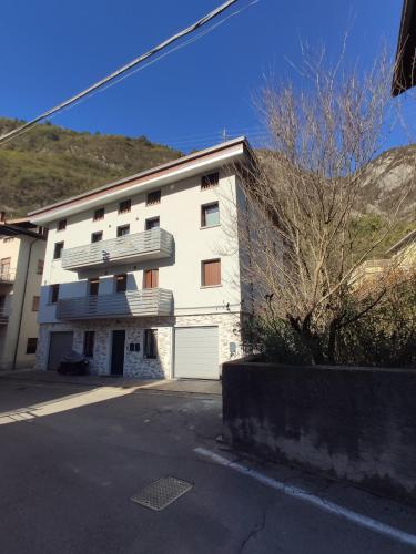 a white building with a balcony on the side of it at Appartamento Cogno in Esine