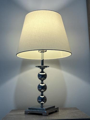 a lamp sitting on top of a table at Napoli Suites Studios Aparthotel in St Julian's