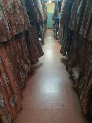 a long aisle of curtains in a store at Bapuji Dormitory Hostel Mumbai in Mumbai
