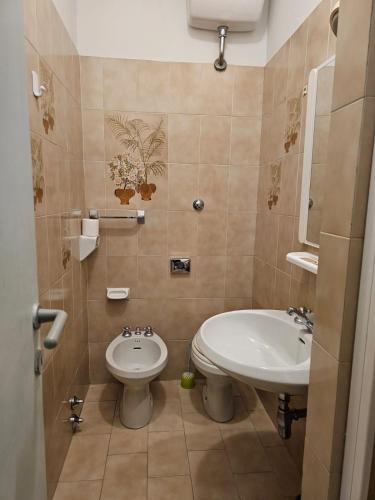 a bathroom with a sink and a toilet at Hotel Liberty in Montecatini Terme
