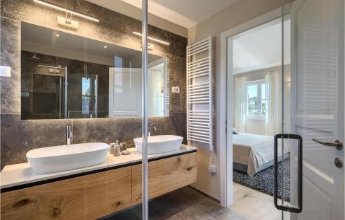 a bathroom with two sinks and a large mirror at Villa Julia Marija in Poreč