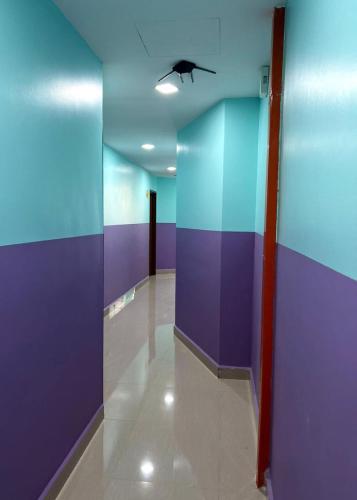 a hallway with purple and blue walls and a ceiling at ARK Business Rawang hotel in Rawang