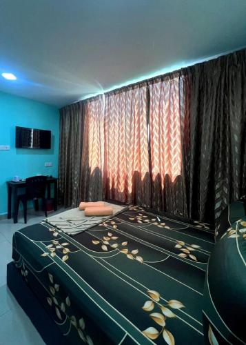 a room with a bed with a curtain and a table at ARK Business Rawang hotel in Rawang
