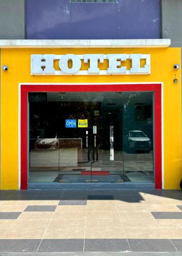 a front door of a store with a sign on it at ARK Business Rawang hotel in Rawang
