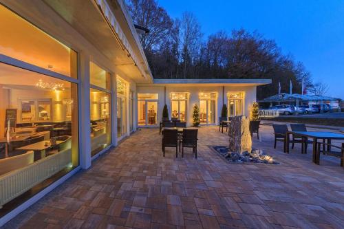 a patio with chairs and tables on a house at Vitalhotel Sonneck in Bad Wörishofen