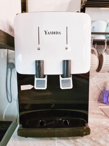 a white coffee maker sitting on top of a counter at Mossy Forest Family Retreat III, 2-8pax, Sunrise View, Cameron Highlands in Cameron Highlands