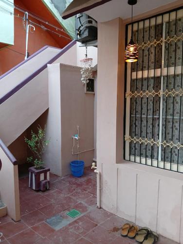 a pair of sandals sitting on the floor in front of a building at Kallidai Home Stay Kumbakonam in Kumbakonam